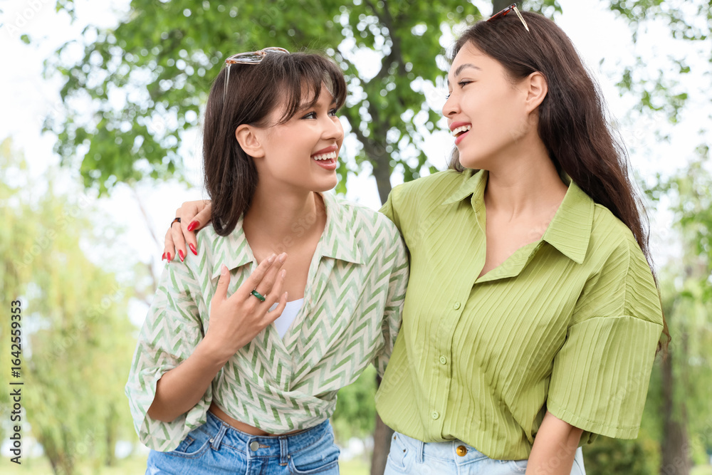 Fototapeta premium Happy young female best friends walking in park
