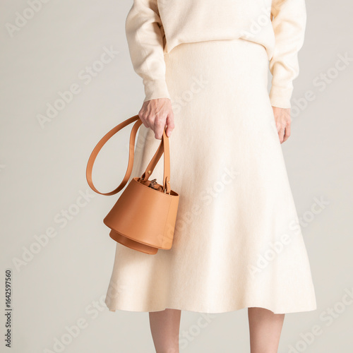 Elegant Beige Outfit Featuring a Stylish Tan Leather Handbag