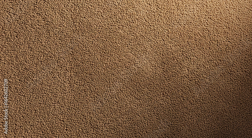 A close up shot of a brown textured fabric with a slightly darker gradient on the right side