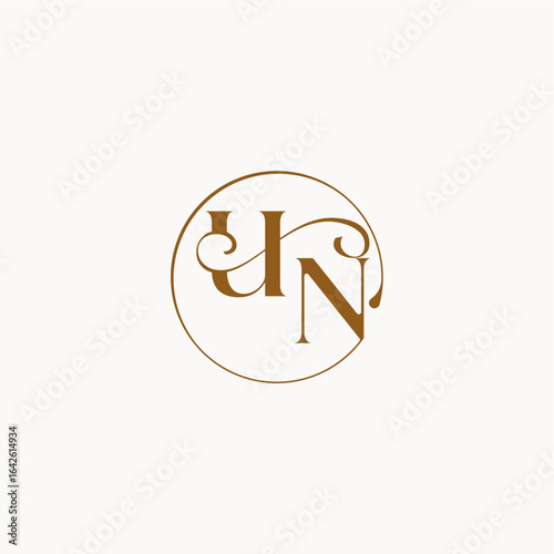 luxurius feeling with flow UN monogram elegant style letter circle fows wedding logo
