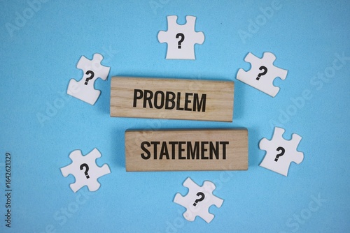 Wooden blocks with 'problem statement' written on them and a white puzzle with a question mark symbol. Problem solving concept. Isolated on an blue background.