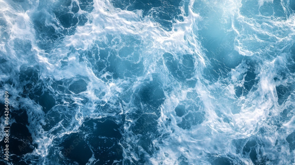 Top-down perspective of rolling coastal waves, intricate foam patterns swirling on azure waters, dramatic wave movement frozen in time, natural sunlight illuminating water surface, photorealistic Top-down perspective of rolling coastal waves, intricate foam patterns swirling on azure waters, dramatic wave movement frozen in time, natural sunlight illuminating water surface, photorealistic