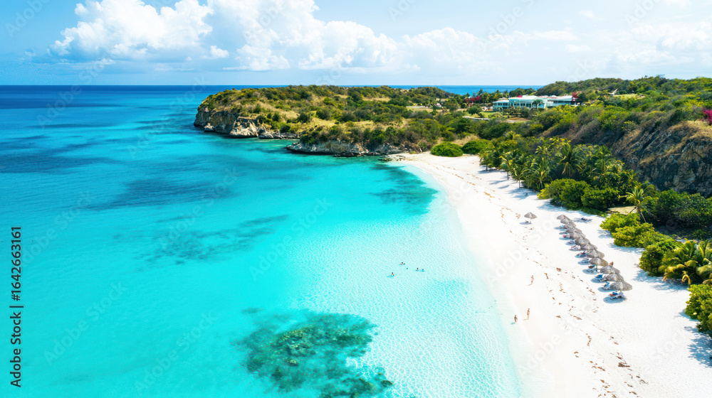 Obraz premium A tropical paradise with turquoise waters, white sand beaches, and a clear, bright sky.