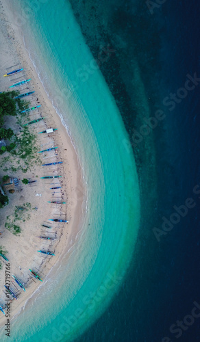 Scenic tropical shoreline with calm, clear blue waters.