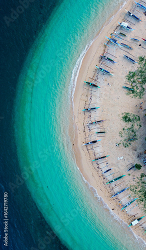 Idyllic island shore with crystal-clear ocean and fishing village.