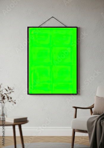 Picture frame mockup with green screen hanging on a wall in a modern interior.