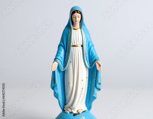 Virgin Mary Statue: A serene image of the Virgin Mary statue, clad in a vibrant blue robe, exuding a sense of faith, devotion, and spiritual reflection. 
