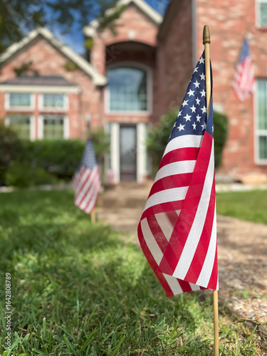 American flags displayed in front of a southern home in honor of the fourth of July. Patriotism concept.