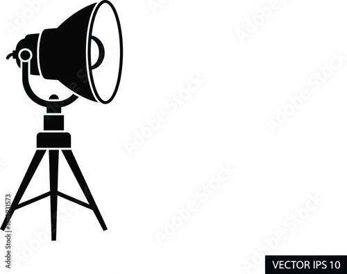Black studio spotlight on tripod, professional lighting equipment