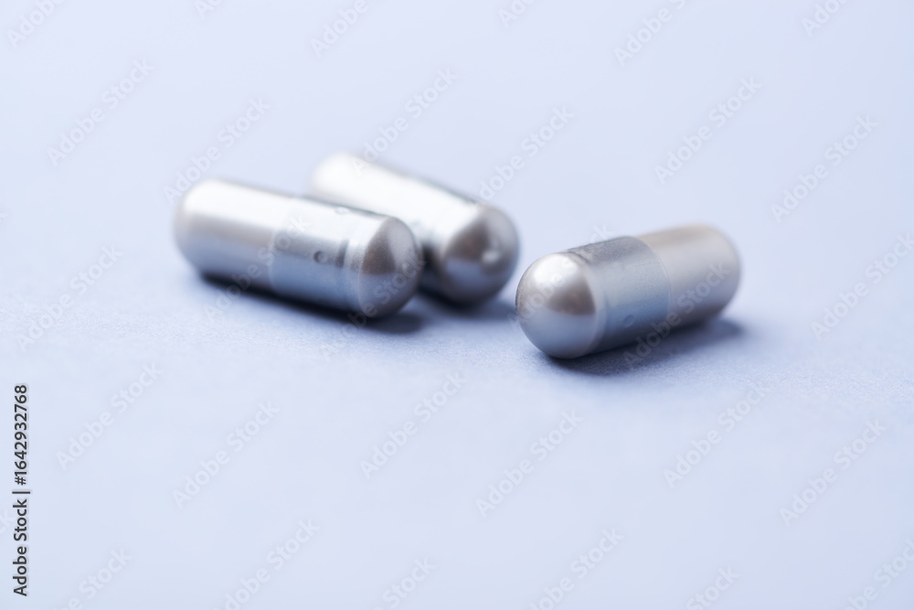 Amino acids capsules on bright background. Soft focus. Close up. Copy space. Amino acids capsules on bright background. Soft focus. Close up. Copy space.