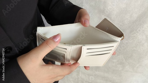 Close-up person opening empty wallet showing broke financial in debt from over expenses. The concept of crisis, inflation, low wages, debts