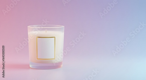 A White Candle in a Glass Jar with a Gold Frame on its Label sits on a Smooth Surface Against a Gradient Pink and Blue Background Showing its Reflection	
