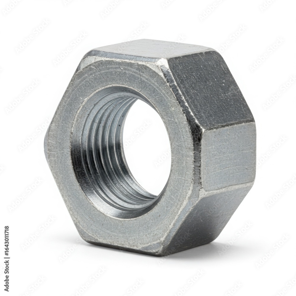 Close up of a hexagonal metal nut with internal threads on a white background Close up of a hexagonal metal nut with internal threads on a white background