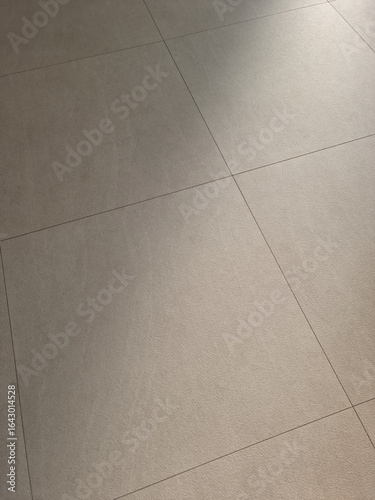 The living room has a beige hardwood floor.	