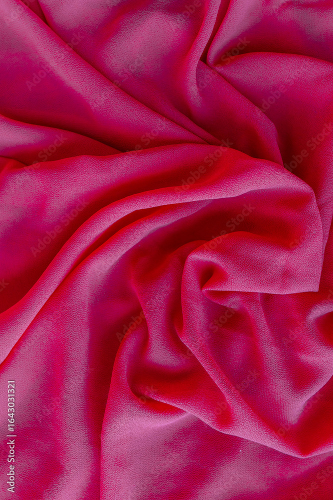 Obraz premium Close-up of vibrant hot pink fabric with rich texture and dramatic drapes. The bold magenta tone exudes energy, passion, and contemporary style, making it perfect for fashion concepts, textile designs