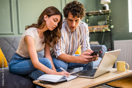 Φωτογραφία Couple discussing home finance while checking bills