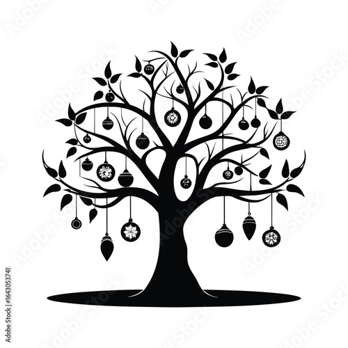 Silhouette of a bare tree adorned with various hanging ornaments and decorations