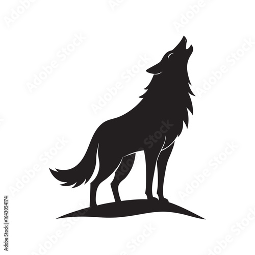 Silhouette of a black wolf howling at the moon atop a grassy mound