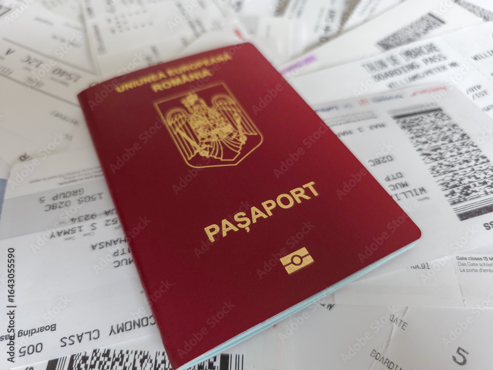 Romanian European Union biometric passport with boarding pass against a white background Romanian European Union biometric passport with boarding pass against a white background
