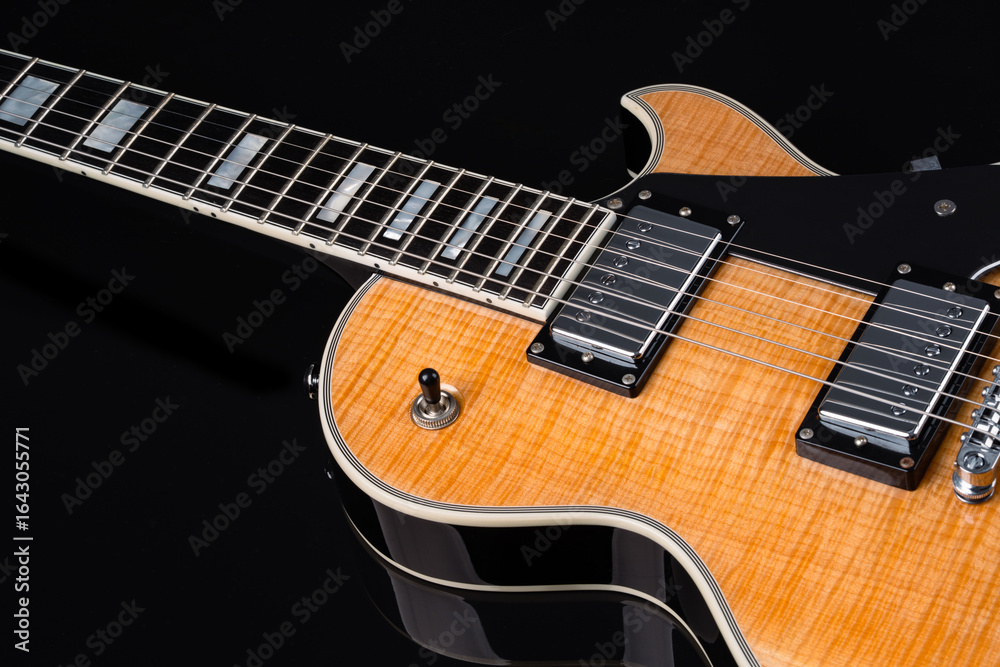 Fototapeta premium Electric guitar with natural pattern isolated on black background.