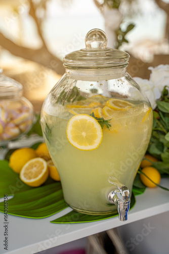 lemonade jar with lemons and herbs