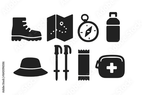 Essential hiking gear items arranged for an outdoor adventure preparation at a campsite during the day
