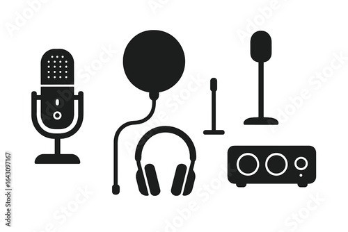 Equipment used for audio production and recording in a studio setting with microphones and headphones