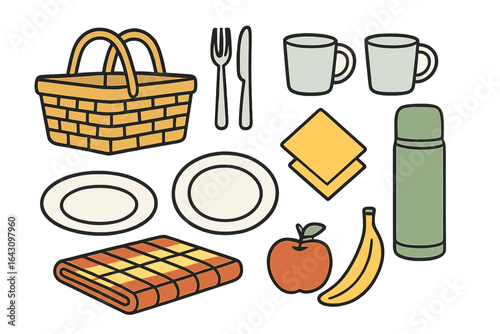 Enjoying a picnic with a basket, plates, utensils, and fresh fruits on a blanket outdoors