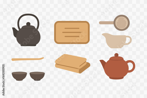Tea preparation tools arranged on a surface with a focus on tea culture and serving in a cozy setting