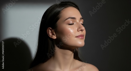 Beautiful woman with glowing skin in soft sunlight