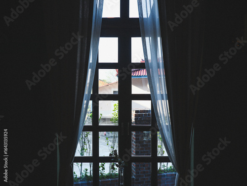 Cafe window covered with curtains. The view from the window