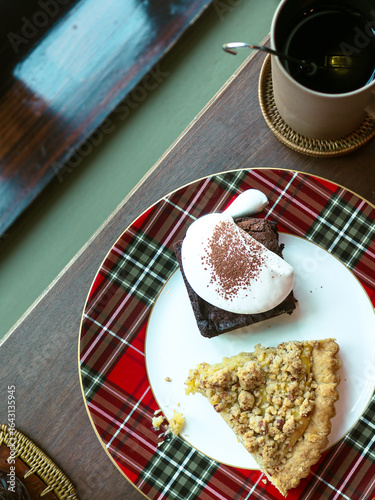 Coffee and chocolate cake on wooden table in coffee shop 