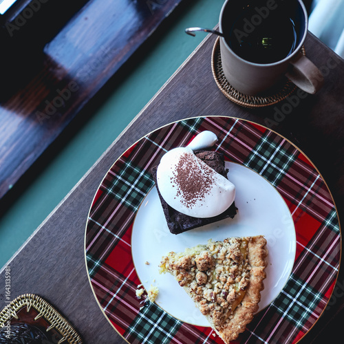 Coffee and chocolate cake on wooden table in coffee shop 