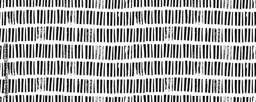 Vertical stripes and dashes seamless pattern. Bamboo or weave texture.