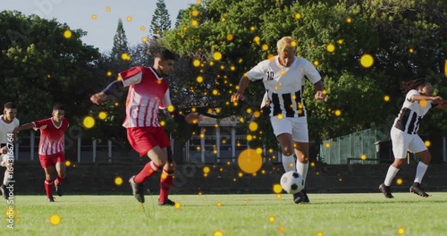 Soccer player dribbling ball evading sliding tackle keeping ball stumbling releasing ball for chase