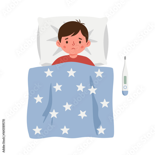 Sick child with a fever lying in bed under a blanket, an unwell young boy with a thermometer resting at home.