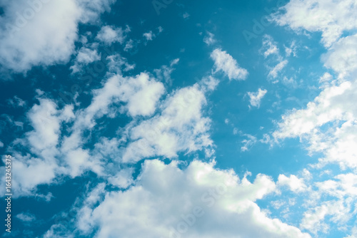 white cumulus clouds on a dark blue sky