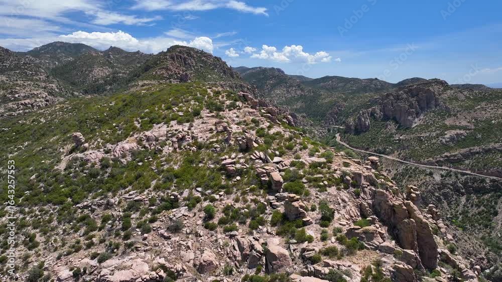 Aerial view of the Santa Catalina Mountains showcasing the rugged terrain with winding roads amidst the Coronado National Forest, Summerhaven, Arizona, United States. Aerial view of the Santa Catalina Mountains showcasing the rugged terrain with winding roads amidst the Coronado National Forest, Summerhaven, Arizona, United States.