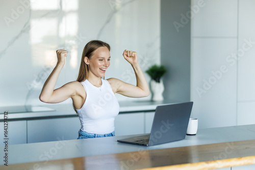 Young attractive with win gesture woman exulting using calculator and laptop for calculating finance rates Free Download Young attractive with win gesture woman exulting using calculator and laptop for calculating finance rates - GFXLoad
