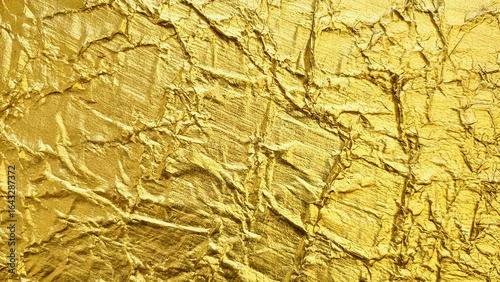 Gold crumpled texture shines as light emphasizes shadows; use for video backdrop, poster design, or print material.