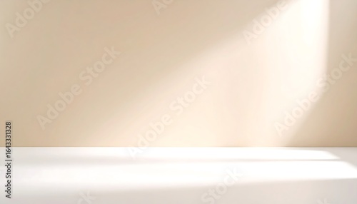 Beige studio backdrop with soft gradient lighting and white floor creating shadows and highlights