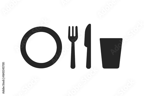 Setting a simple dining table with essential utensils for a casual meal at home in the evening