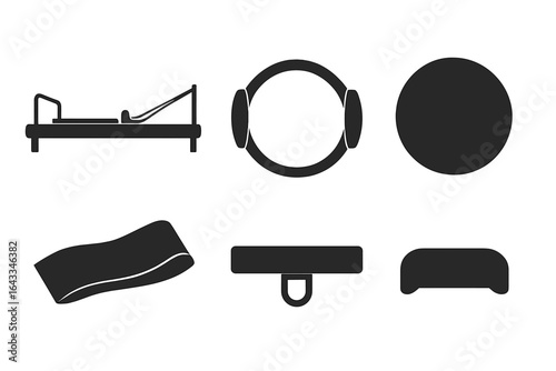 Pilates equipment including reformer, resistance band, and stability ball used in a fitness session in the studio