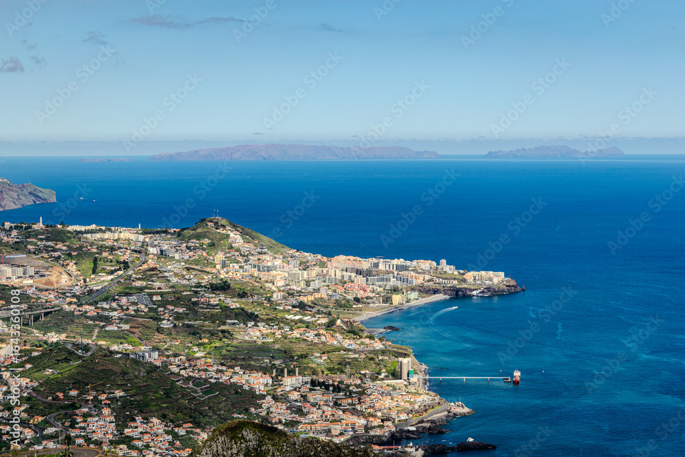 Fototapeta premium Machico Town and Hillside View from the Coast