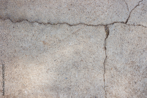 Close-up of cracked and rough concrete for overlay background.