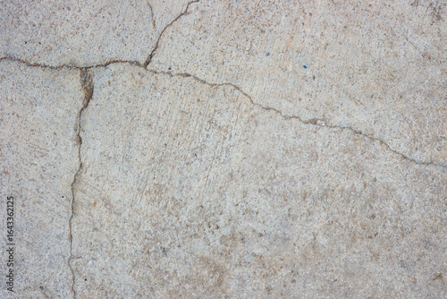 Close-up of cracked and rough concrete for overlay background.