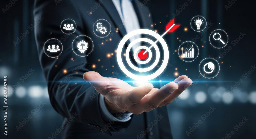 Fototapeta premium Business Goals and Objectives A Conceptual Image of a Hand Holding a Target with an Arrow Surrounded by Business and Strategy Related Icons