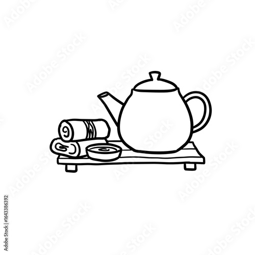 Herbal tea pot and spa set with rolled towels on wooden tray  