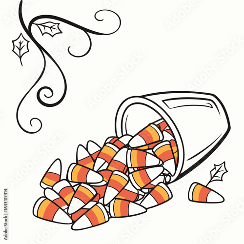 A bucket of candy corn spills out with decorative fall leaves and vines