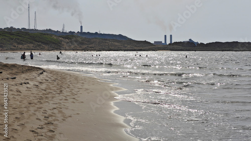 Obraz na plátně Sunlit Waves and Swimmers on a Cyprus Beach